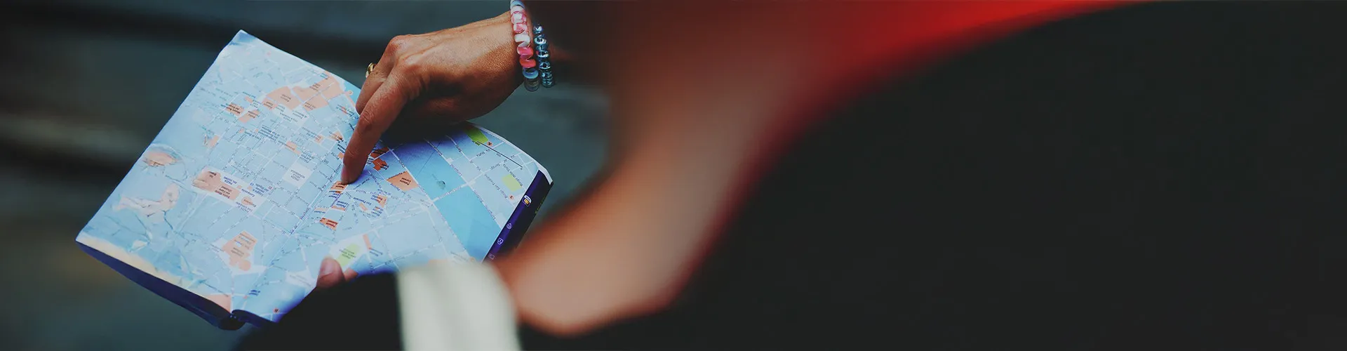 Traveler pointing at a city map